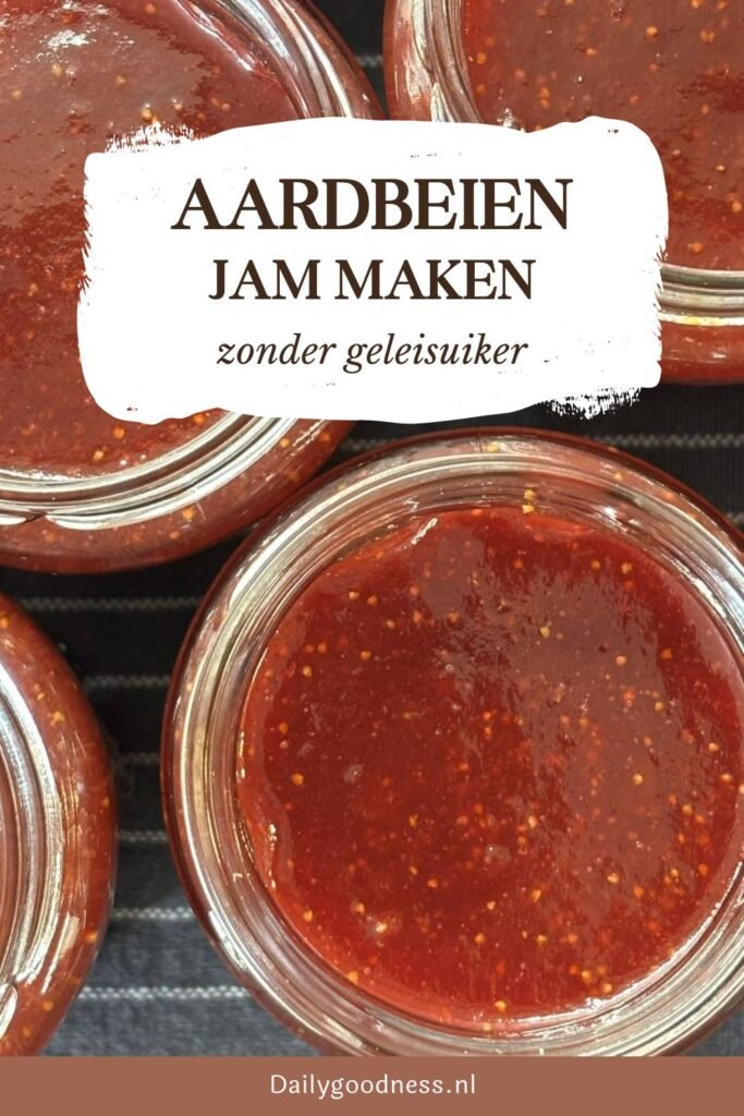 Potten met versgemaakte aardbeienjam staan op een theedoek af te koelen