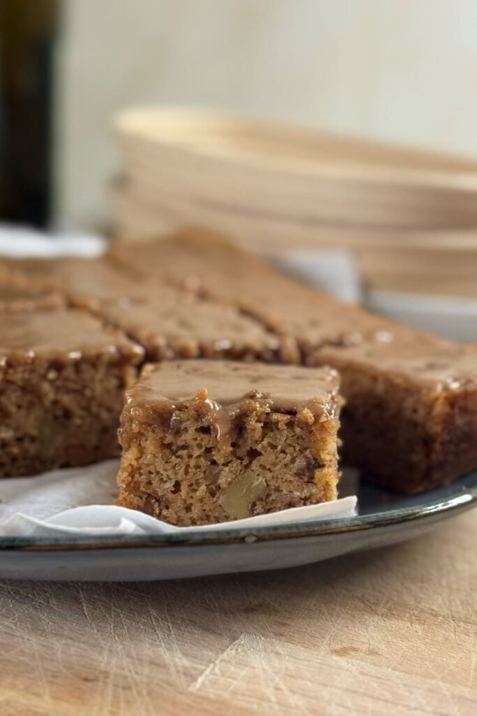 Blokjes versgebakken en gesneden zuurdesem cake met speculaaskruiden liggen op een bord op tafel